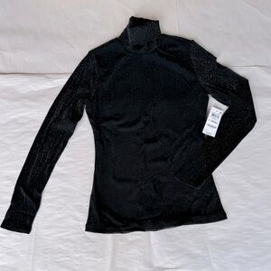 Woman’s black turtleneck blouse